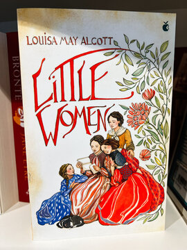 Little Women by Louisa May Alcott cover with sisters reading together amid floral design