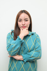 Portrait of a young Asian woman against white background thinking
