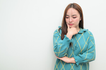 Portrait of a young Asian woman against white background thinking