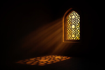 Sunlight streaming through an arched patterned window in a dark room