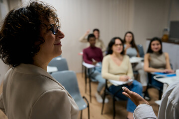 University professor teaching diverse adult students in classroom