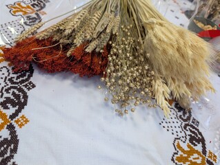 Bundle of dried grain stems and wheat ears prepared for decoration or floral arrangements.