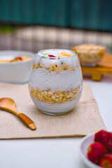 Delicious and healthy bowl of oatmeal cereal topped generously with fresh sliced bananas, vibrant strawberries, and kiwi pieces ready for a nutritious morning meal.