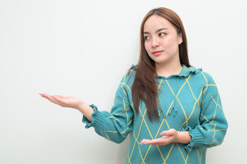 Portrait of a young Asian woman against white background showing copy space