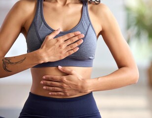 Woman practicing mindful breathing exercise with hands on chest and abdomen
