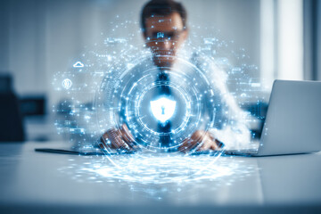 Digital cybersecurity concept with a person using a laptop and holographic security lock icon