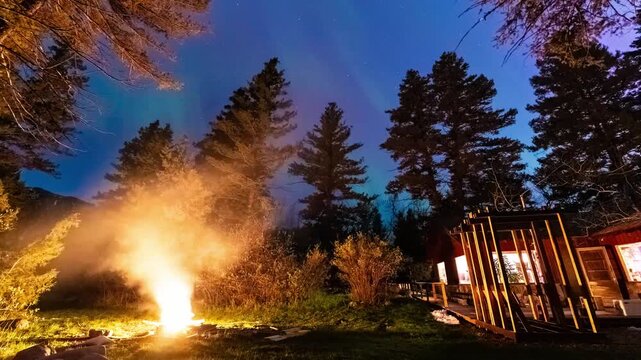 Northern lights over bonfire backyard 