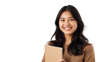 A young woman holding a book and smiling on