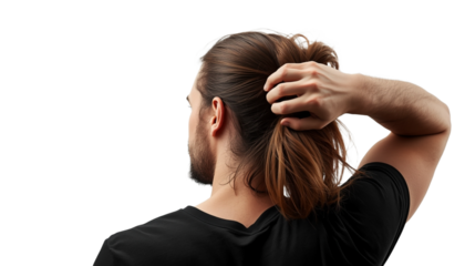 A man with long hair tying his ponytail on a