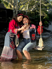 Group of friends wearing vibrant ethnic fashion having fun by the water.