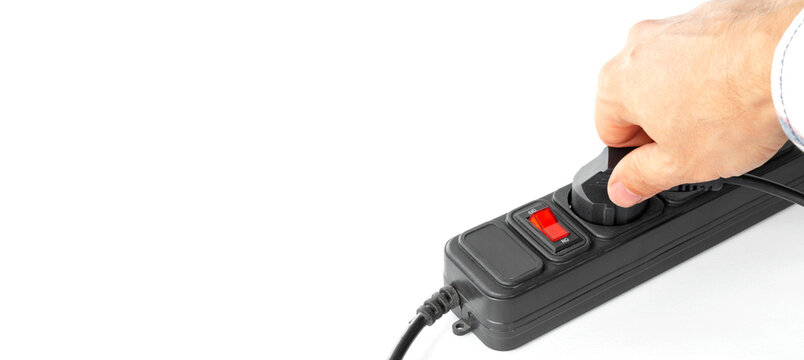 Hand inserting plug into surge protector, energy saving concept, shutdown, isolated, with space for text.