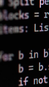 Vibe coding , AI background generating python code. Close-up of blurred computer code on a black screen with white text.