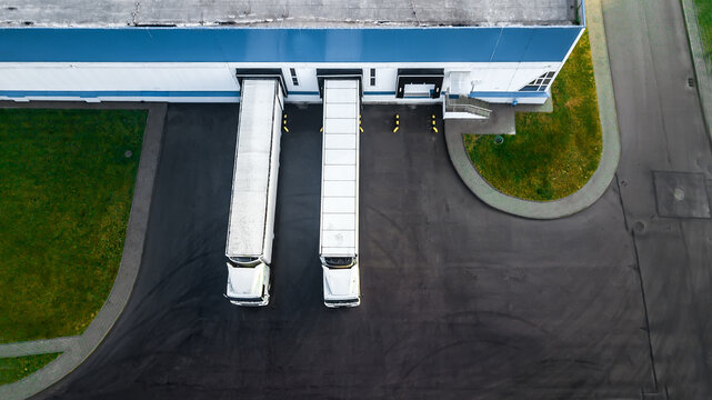 trucks are loaded in a modern logistics center. aerial view.