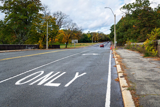 Quiet suburban roadway showing a right turn only lane marking in Brighton, Boston area, Massachusetts, USA

