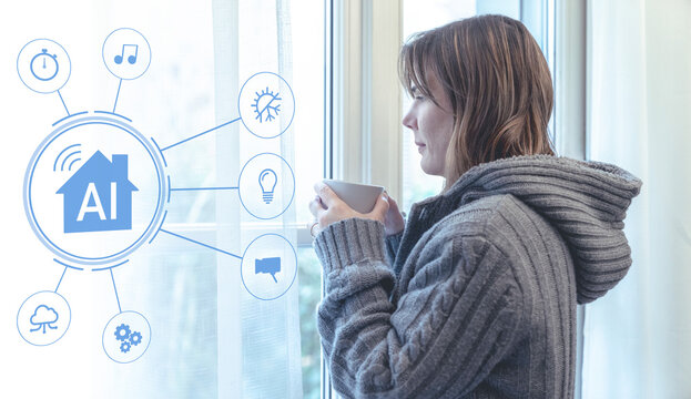 Young woman wearing a grey knit sweater holding a cup of hot drink stands by a window in her smart home controlled by an artificial intelligence system that manages heating and lighting automation - Powered by Adobe