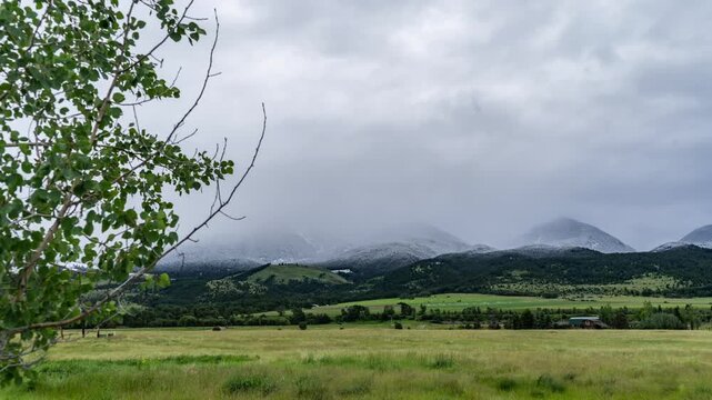 Mist and snow flowing over mountains in summer 