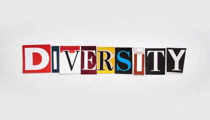 The word DIVERSITY composed of multicolored cutout letters from various magazines on a simple white paper background. A powerful conceptual image representing inclusion, equality, and culture.