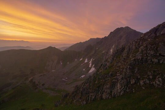 Aerial view of rugged peaks kissed by the soft glow of dawn, where shadows dance on the slopes of Nizke Tatry, Krupova Hola, Zilina Region, Slovakia.
