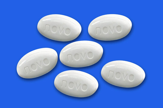 Pills from Novo Nordisk pharmaceutical company lies on a blue background. Copenhagen, Denmark - December 29, 2025.