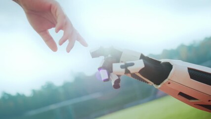 Coach adjusting robotic sensor outdoors, Prototype wearable device tested on sunny athletic field with coach