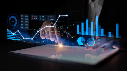 Person interacting with digital data visualization on a touchscreen tablet, showcasing financial metrics and analytics for effective business decision-making. Scalp