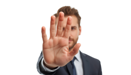 A businessman in a suit holding up his hand in a stop gesture on