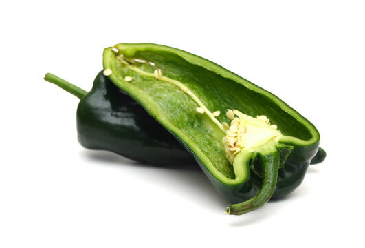 Dark green poblano peppers isolated on white