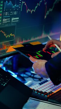 Cryptocurrency market technical analysis tablet blockchain trading charts. Professional trader hands holding digital tablet displaying candlestick patterns volume indicators price movements