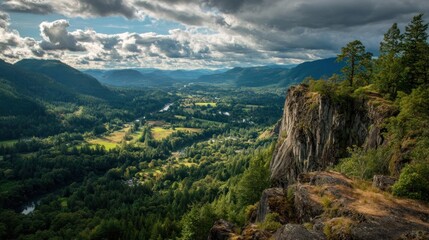 Fototapeta premium Dramatic Landscape - Cliffside View of Lush Valley and Cloudy Sky.