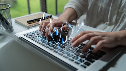 A person types on a keyboard with a digital financial graph overlay, representing modern business analysis and technology in a professional workspace environment. Scalp