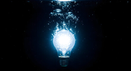 Glowing light bulb in dark space