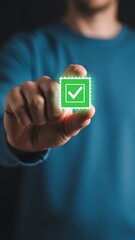 A person s hand interacting with a glowing green checkmark symbol representing confirmation or approval