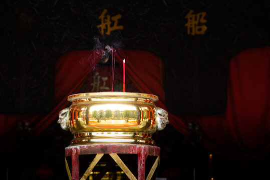 Burning Incense Sticks in a Golden Incense Burner Inside a Traditional Chinese Temple