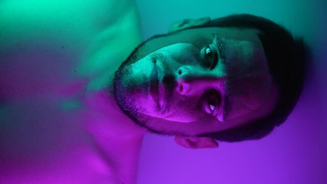 Male Portrait Submerged in Water with Neon Glow