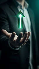 A businessman holding a glowing green arrow representing growth success and forward momentum