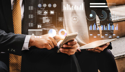 Two business professionals engage in data analysis with digital devices, showcasing modern technology and artificial intelligence to enhance business insights. Gantry