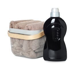 Laundry basket with soft towels and bottle of detergent isolated on white