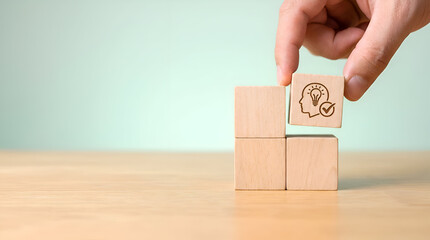 Hand placing wooden block with creative idea symbol on top