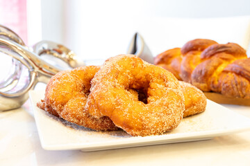Freshly baked cinnamon sugar doughnuts And fresh challah