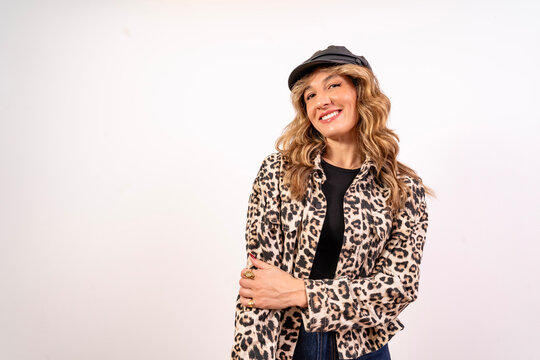 Stylish smiling woman wearing leopard print shirt and cap