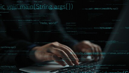 A close-up view of hands typing on a laptop keyboard in a dark setting, with glowing lines of code projected on the screen, highlighting the world of coding and technology. Xenic