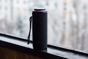 a music speaker against a natural backdrop