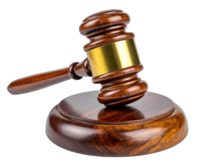 A wooden gavel with brass band, resting on a matching wooden sound block, isolated on black