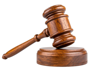 A detailed studio shot of a brown wooden gavel and its circular base set on a dark background