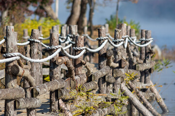 Naklejka premium Rustic Wooden Fence by Lakeside Path