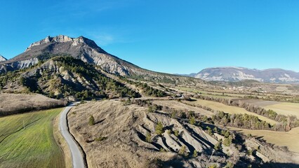 Winter aerial drone view of the mountains seen from the Sigottier Forest, Hautes-Alpes, France