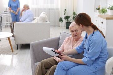 Care worker asking senior woman about her wellbeing at retirement home