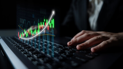 A business professional engages with a laptop, while a digital graph highlights financial growth trends in a sleek office environment focused on investment analysis. Impute