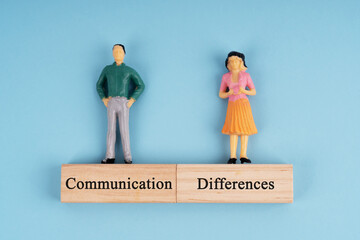 Man and woman figurine with text communication differences  on blue background