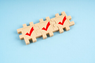 Jigsaw puzzle with check mark sign on blue background